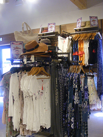 Gondola with Shelves and Stepped Arms to Display Ladies' Clothing and Accessories.